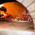 Well placed pizzas in a wood burning oven