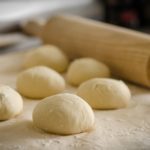 Small pizza doughs and a rolling pin