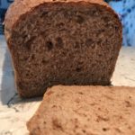 Sliced walnut bread showing the bits of walnuts and texture of the crumb.